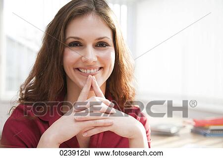 portrait of young businesswoman sitting at desk View Large Photo Image Stock Image - portrait of young businesswoman sitting at desk. Fotosearch