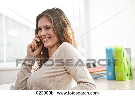 Stock Image - portrait of young businesswoman talking on mobile phone. Fotosearch