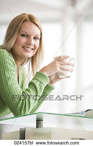 Stock Image - portrait of young businesswoman with cup. Fotosearch