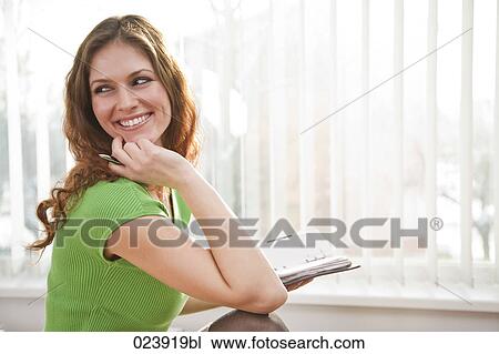 Stock Image - portrait of young businesswoman with diary. Fotosearch