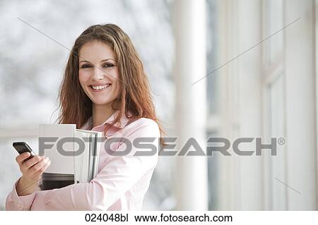 Stock Image - portrait of young businesswoman with mobile phone. Fotosearch