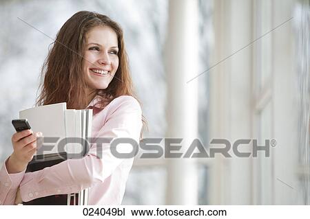 Stock Image - portrait of young businesswoman with mobile phone. Fotosearch