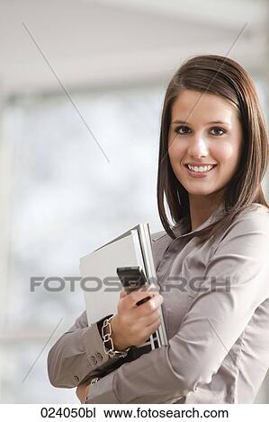 portrait of young businesswoman with documents and mobile phone View Large Photo Image Stock Image - portrait of young businesswoman with documents and mobile phone. Fotosearch