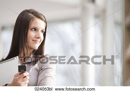 portrait of young businesswoman with documents and mobile phone View Large Photo Image Stock Image - portrait of young businesswoman with documents and mobile phone. Fotosearch