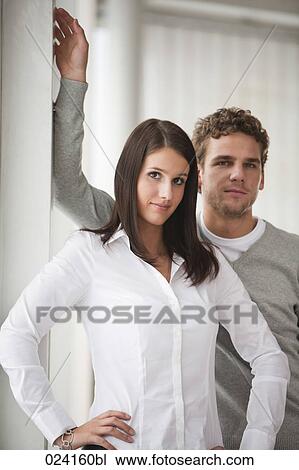 Stock Image - portrait of young businesswoman with male colleague. Fotosearch