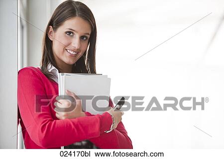 portrait of young businesswoman with documents and mobile phone View Large Photo Image Stock Image - portrait of young businesswoman with documents and mobile phone. Fotosearch