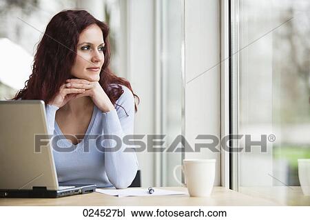 Stock Image - portrait of young businesswoman with laptop computer. Fotosearch