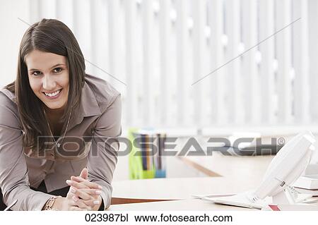 portrait of young busineswoman at desk View Large Photo Image Stock Image - portrait of young busineswoman at desk. Fotosearch