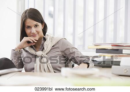 portrait of young busineswoman at desk View Large Photo Image Stock Image - portrait of young busineswoman at desk. Fotosearch