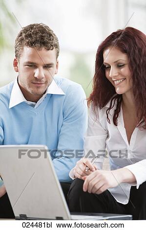 portrait of young couple at home in front of laptop computer View Large Photo Image Stock Image - portrait of young couple at home in front of laptop computer. Fotosearch