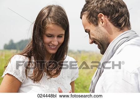 Stock Image - portrait of young couple flirting with each other. Fotosearch