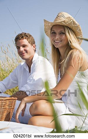 portrait of young couple having picnic in meadow View Large Photo Image Stock Image - portrait of young couple having picnic in meadow. Fotosearch