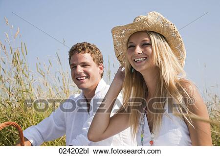 portrait of young couple having picnic in meadow View Large Photo Image Stock Image - portrait of young couple having picnic in meadow. Fotosearch