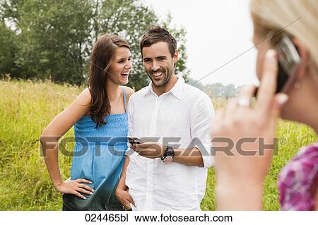 Stock Image - portrait of young couple with mobile phone. Fotosearch