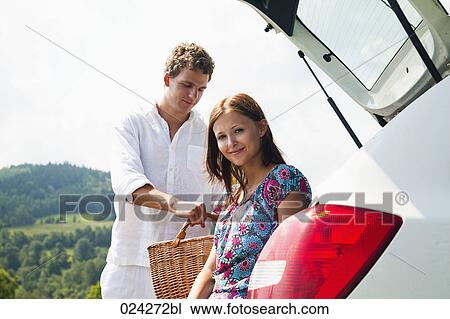 portrait of young couple with picnic basket at car View Large Photo Image Stock Image - portrait of young couple with picnic basket at car . Fotosearch
