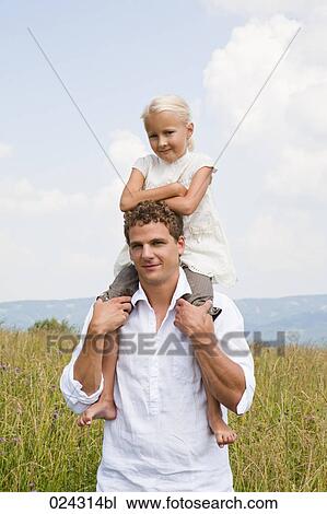 portrait of young man carrying daughter on his shoulders View Large Photo Image Stock Image - portrait of young man carrying daughter on his shoulders. Fotosearch