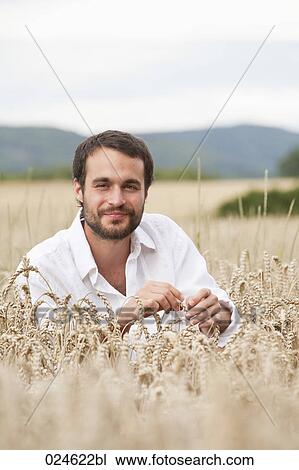 portrait of young man in crop field View Large Photo Image Stock Image - portrait of young man in crop field. Fotosearch