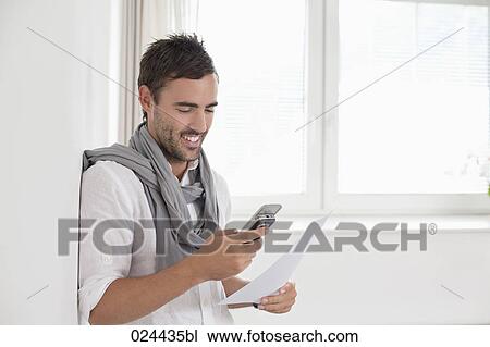 portrait of young man in empty room with mobile phone View Large Photo Image Stock Image - portrait of young man in empty room with mobile phone. Fotosearch