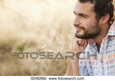 Stock Image - portrait of young man in front of field. Fotosearch