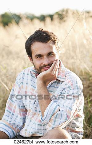 Stock Image - portrait of young man in front of field. Fotosearch