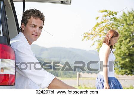 portrait of young man sitting in trunk of car View Large Photo Image Stock Image - portrait of young man sitting in trunk of car. Fotosearch