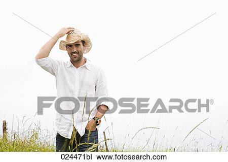portrait of young man standing in meadow View Large Photo Image Stock Image - portrait of young man standing in meadow. Fotosearch