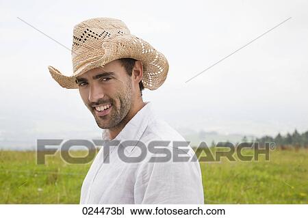 portrait of young man standing in meadow View Large Photo Image Stock Image - portrait of young man standing in meadow. Fotosearch