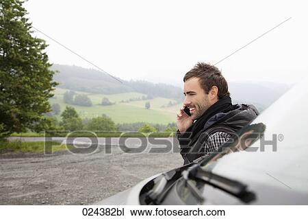 Stock Image - portrait of young man talking on mobile phone. Fotosearch