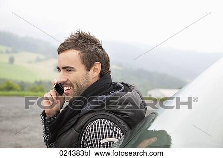 portrait of young man talking on mobile phone View Large Photo Image Stock Image - portrait of young man talking on mobile phone. Fotosearch