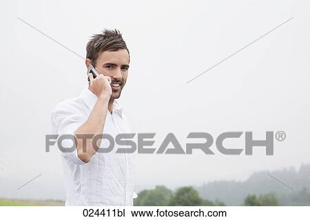 portrait of young man talking on mobile phone View Large Photo Image Stock Image - portrait of young man talking on mobile phone. Fotosearch