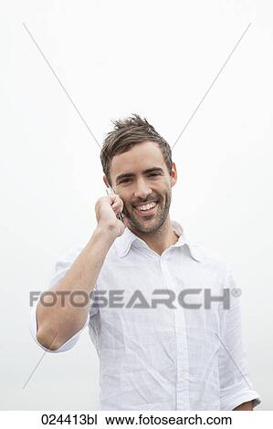 portrait of young man talking on mobile phone View Large Photo Image Stock Image - portrait of young man talking on mobile phone. Fotosearch