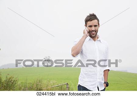 portrait of young man talking on mobile phone View Large Photo Image Stock Image - portrait of young man talking on mobile phone. Fotosearch