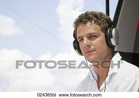 Stock Image - portrait of young man with earphones. Fotosearch