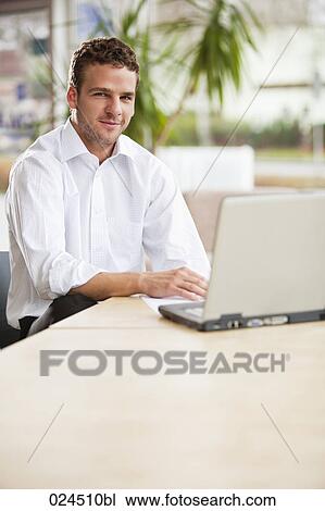 Stock Image - portrait of young man with laptop computer. Fotosearch