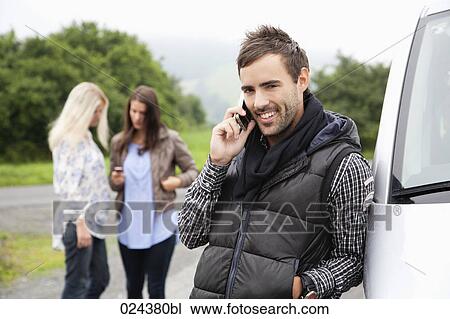 portrait of young man with mobile phone at car View Large Photo Image Stock Image - portrait of young man with mobile phone at car. Fotosearch