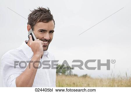 portrait of young man with mobile phone View Large Photo Image Stock Image - portrait of young man with mobile phone. Fotosearch