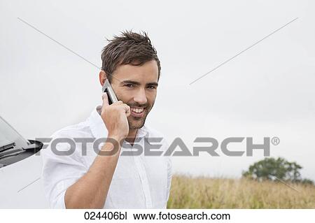 Stock Image - portrait of young man with mobile phone. Fotosearch