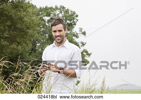 portrait of young man with mobile phone View Large Photo Image Stock Image - portrait of young man with mobile phone. Fotosearch