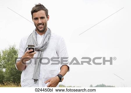 Stock Image - portrait of young man with mobile phone. Fotosearch