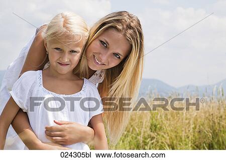 portrait of young woman and daughter in meadow View Large Photo Image Stock Image - portrait of young woman and daughter in meadow. Fotosearch