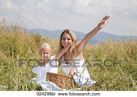 portrait of young woman and daughter sitting in meadow View Large Photo Image Stock Image - portrait of young woman and daughter sitting in meadow. Fotosearch