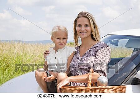 portrait of young woman and daughter with picnic basket at car View Large Photo Image Stock Image - portrait of young woman and daughter with picnic basket at car. Fotosearch