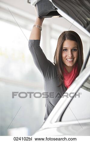 portrait of young woman at car dealer View Large Photo Image Stock Image - portrait of young woman at car dealer. Fotosearch