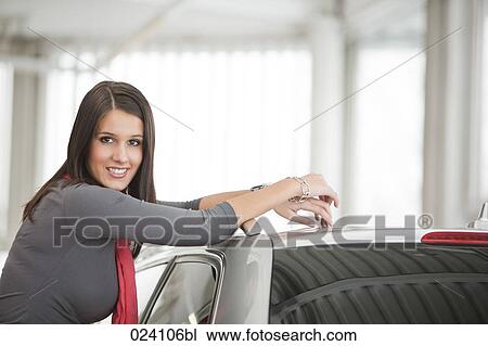 portrait of young woman at car dealer View Large Photo Image Stock Image - portrait of young woman at car dealer. Fotosearch