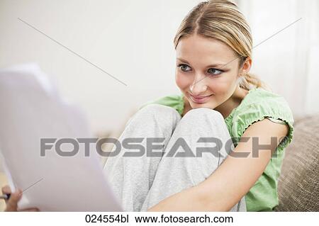 portrait of young woman at home reading letter View Large Photo Image Stock Image - portrait of young woman at home reading letter. Fotosearch