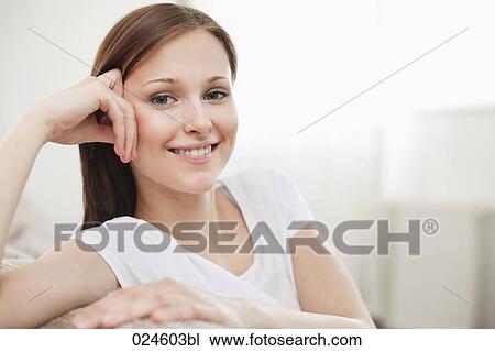 Stock Image - portrait of young woman at home. Fotosearch