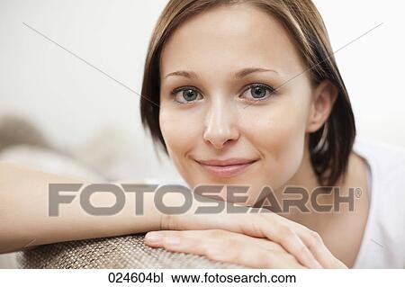 Stock Image - portrait of young woman at home. Fotosearch