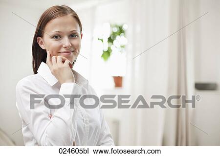 Stock Image - portrait of young woman at home. Fotosearch