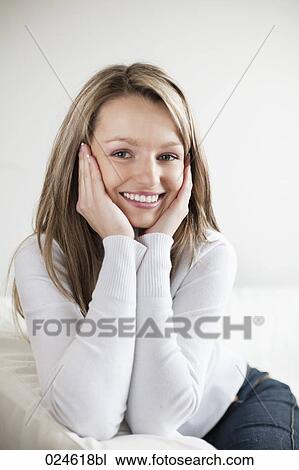 Stock Image - portrait of young woman at home. Fotosearch