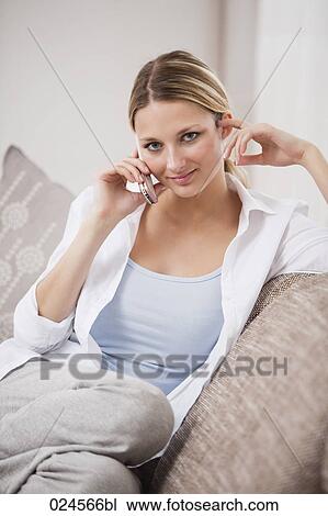 portrait of young woman at home talking on mobile phone View Large Photo Image Stock Image - portrait of young woman at home talking on mobile phone. Fotosearch
